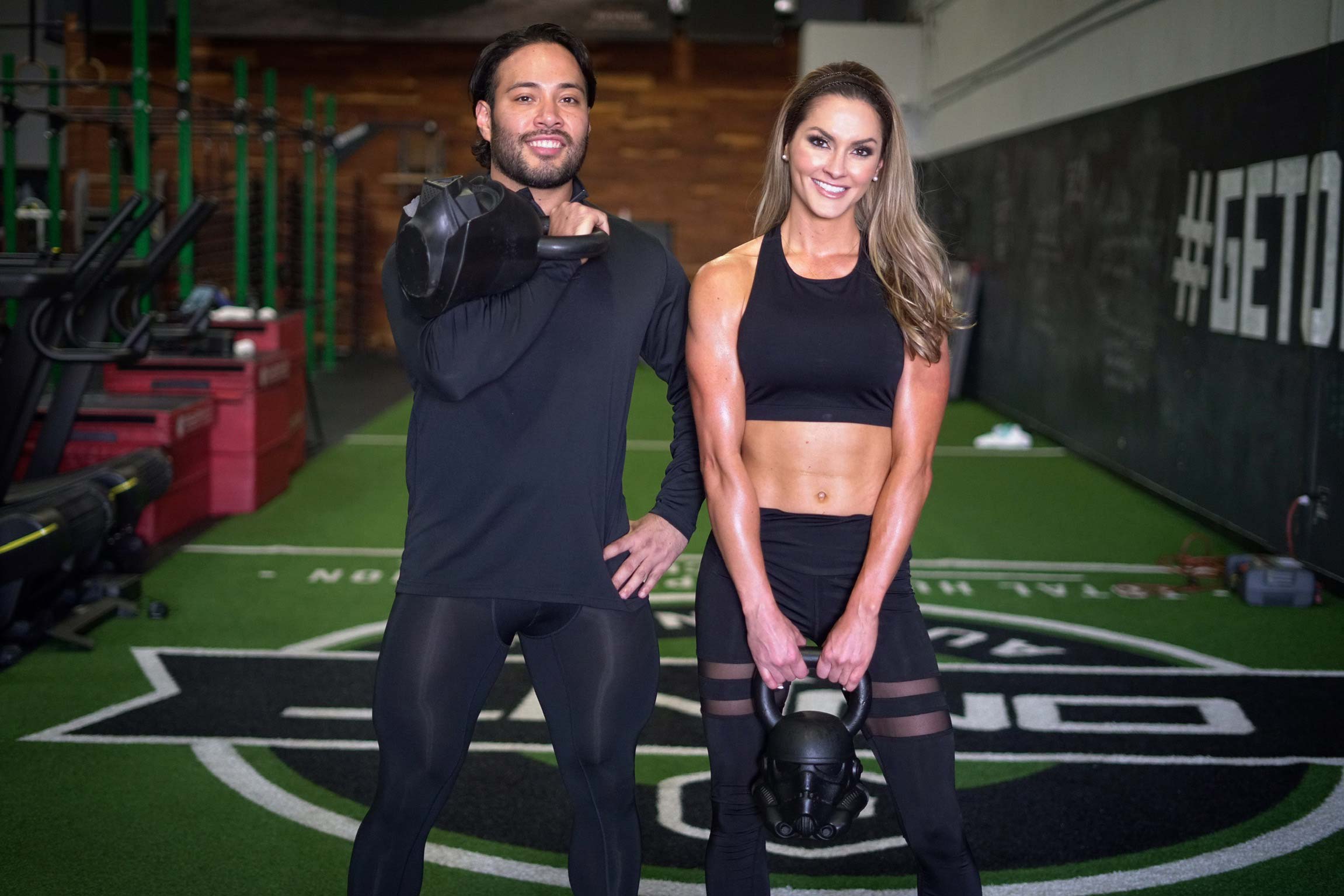 Coach posing with member while smiling